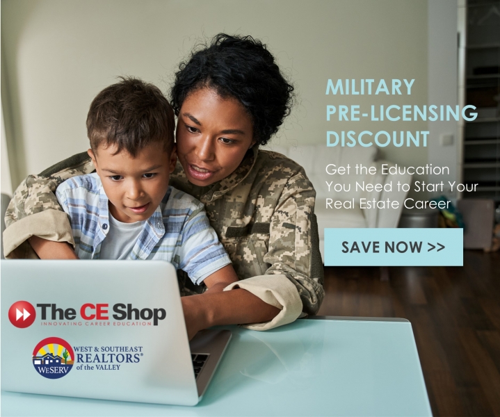 Boy Sitting on the Military Mothers Lap while looking at a Lapto